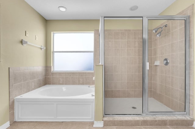 bathroom featuring tile patterned floors and independent shower and bath