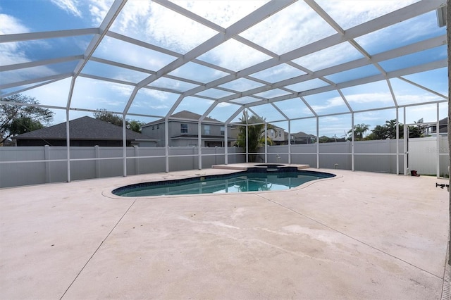 view of swimming pool featuring glass enclosure and a patio area