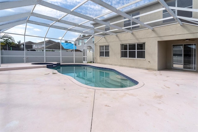 view of swimming pool featuring an in ground hot tub, glass enclosure, and a patio area