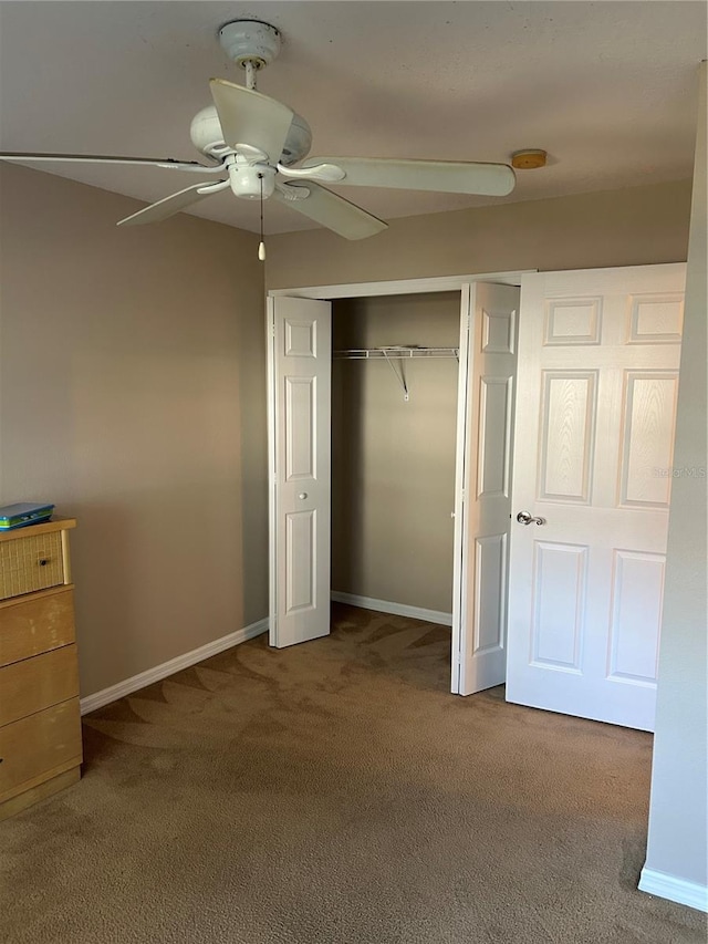 unfurnished bedroom with carpet floors, a closet, and ceiling fan