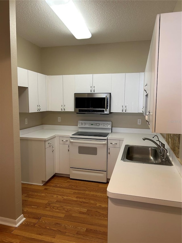 kitchen featuring sink, dark wood-type flooring, white cabinetry, electric range, and a textured ceiling