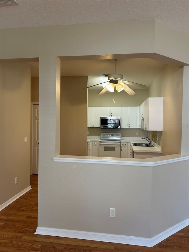 kitchen featuring white cabinetry, white electric range oven, sink, and dark wood-type flooring