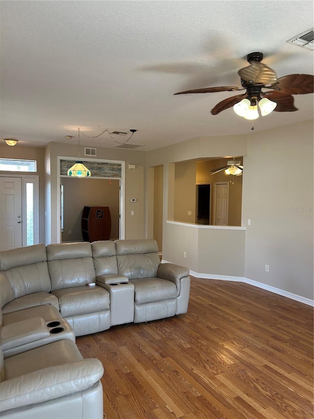 unfurnished living room featuring hardwood / wood-style flooring and a textured ceiling