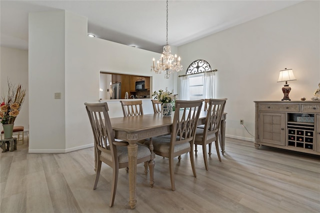 dining space with an inviting chandelier and light hardwood / wood-style floors