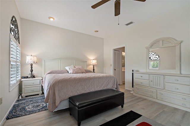 bedroom featuring multiple windows, ceiling fan, and light wood-type flooring