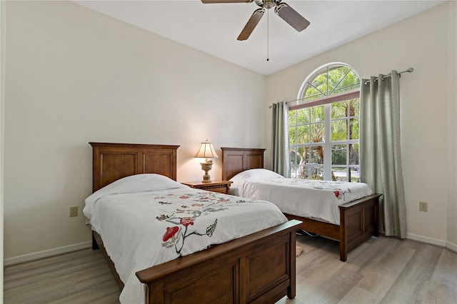 bedroom with light hardwood / wood-style floors and ceiling fan