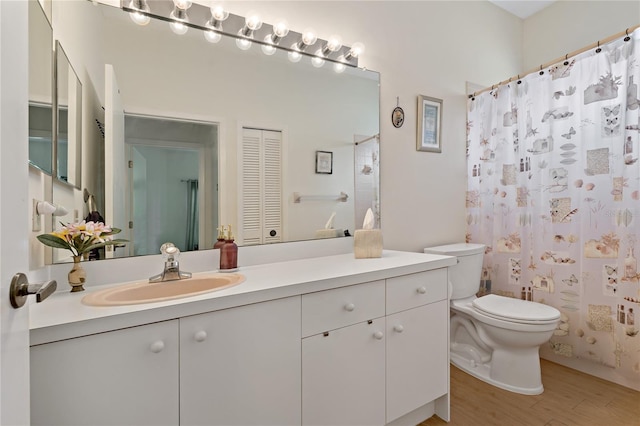 bathroom featuring hardwood / wood-style flooring, vanity, toilet, and a shower with shower curtain