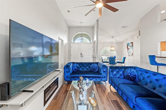 living room featuring dark hardwood / wood-style floors and ceiling fan