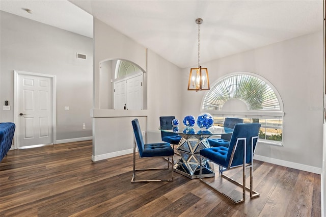 dining room with lofted ceiling, a chandelier, and dark hardwood / wood-style flooring