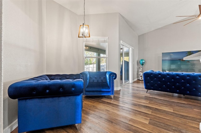 living room featuring wood-type flooring, vaulted ceiling, and ceiling fan