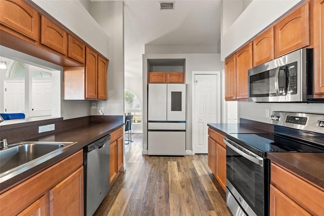 kitchen featuring stainless steel appliances, dark hardwood / wood-style floors, and sink