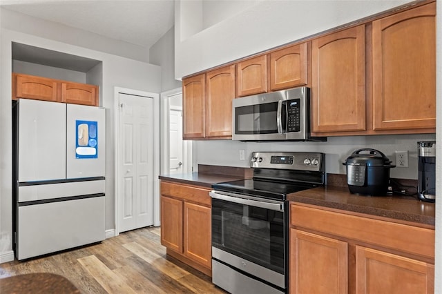 kitchen with stainless steel appliances and light wood-type flooring