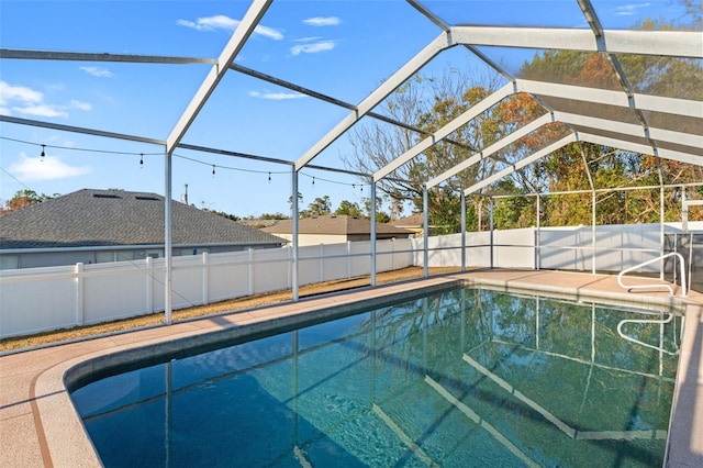 view of swimming pool with a lanai and a patio area