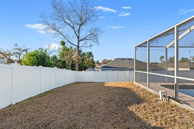 view of yard with glass enclosure