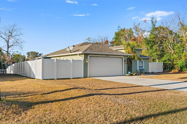 ranch-style home featuring a garage and a front yard