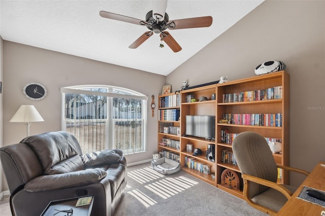 carpeted home office featuring vaulted ceiling and ceiling fan