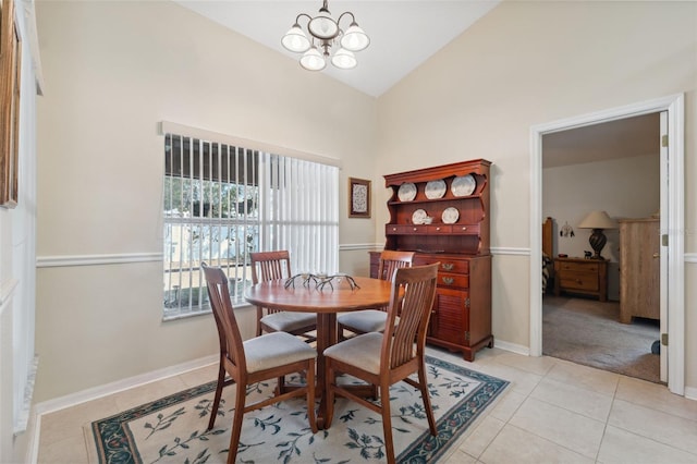 dining space with high vaulted ceiling, light tile patterned floors, and a chandelier