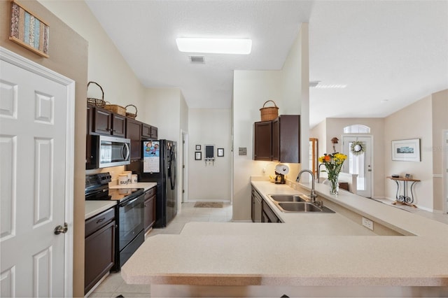 kitchen featuring dark brown cabinets, sink, kitchen peninsula, and black appliances