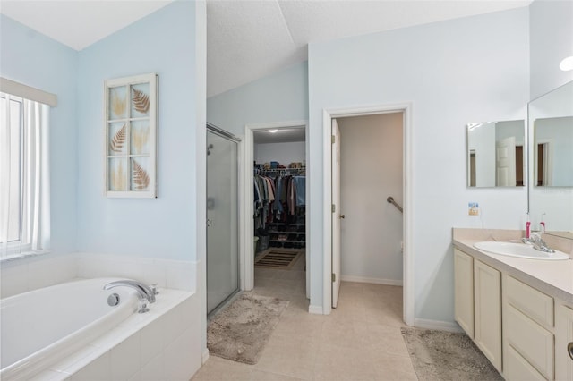 bathroom with vanity, tile patterned flooring, lofted ceiling, and independent shower and bath