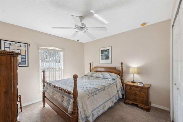 carpeted bedroom featuring a textured ceiling, ceiling fan, and a closet