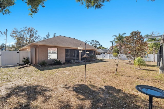 rear view of property featuring a yard