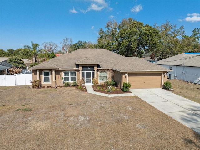 ranch-style house with a garage, central AC, and a front lawn