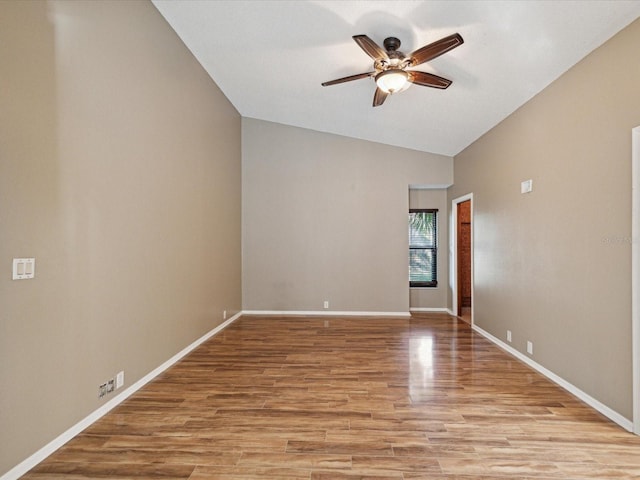 unfurnished room featuring vaulted ceiling, baseboards, ceiling fan, and light wood finished floors