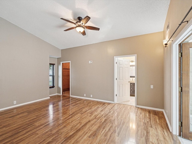 unfurnished bedroom with baseboards, a textured ceiling, and light wood finished floors