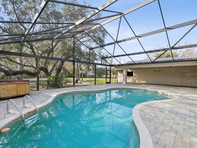 pool with a patio, a lanai, and a hot tub