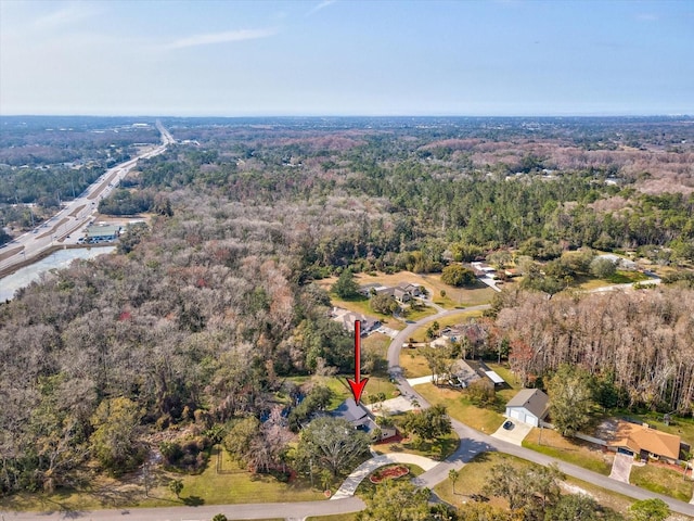 drone / aerial view with a wooded view