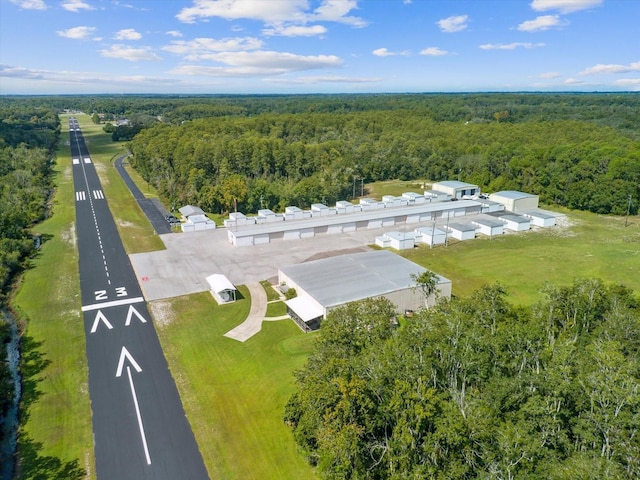 birds eye view of property with a forest view