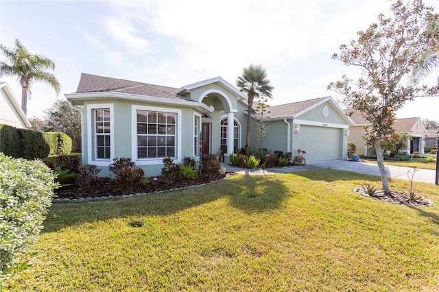 single story home featuring a garage and a front lawn