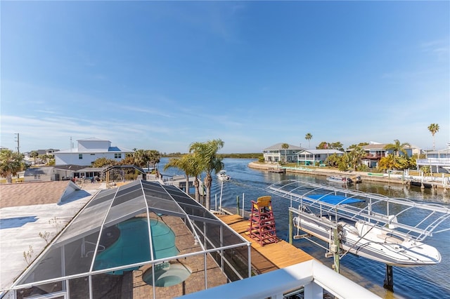 dock area featuring a water view and glass enclosure