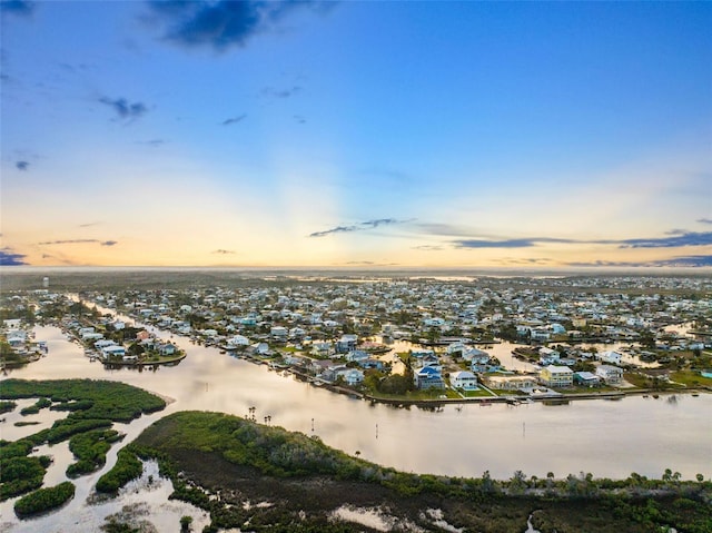 aerial view at dusk with a water view