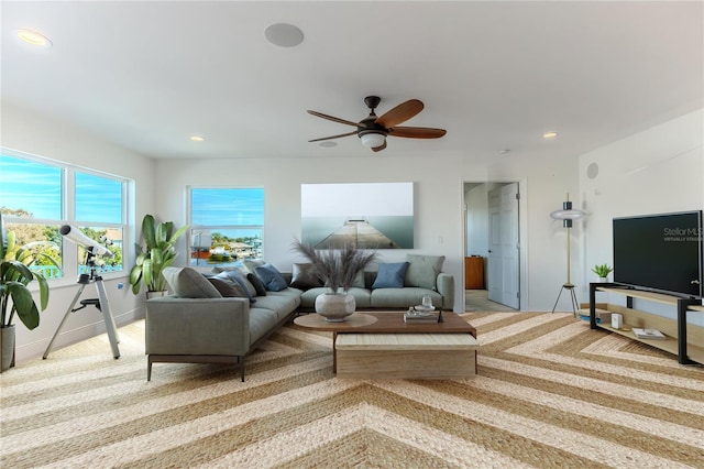 living room featuring light colored carpet and ceiling fan