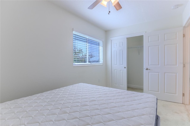 bedroom featuring ceiling fan, a closet, and light carpet