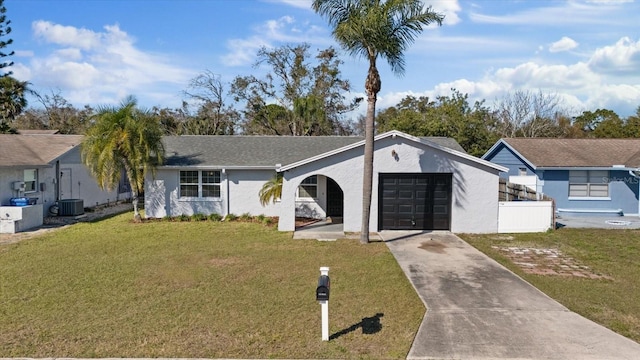 single story home featuring a garage, central AC, and a front yard