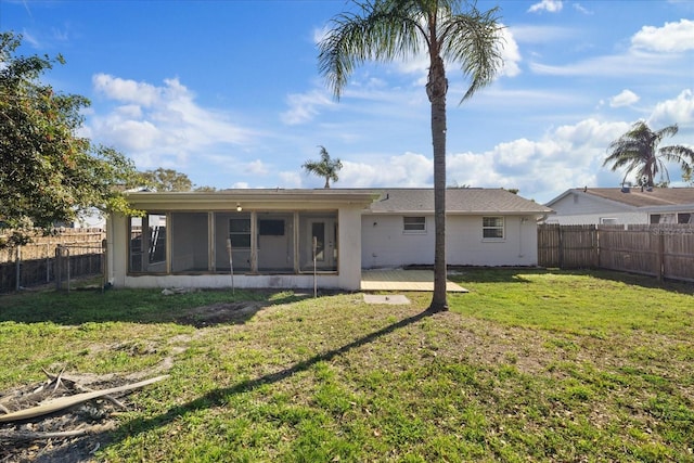 back of house featuring a sunroom and a yard