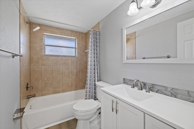 full bathroom with shower / bath combination with curtain, hardwood / wood-style flooring, vanity, toilet, and a textured ceiling