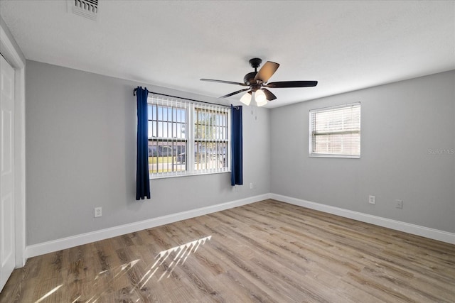 empty room featuring ceiling fan and light hardwood / wood-style floors