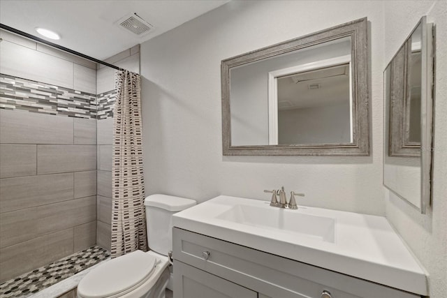 bathroom featuring a shower with curtain, vanity, and toilet