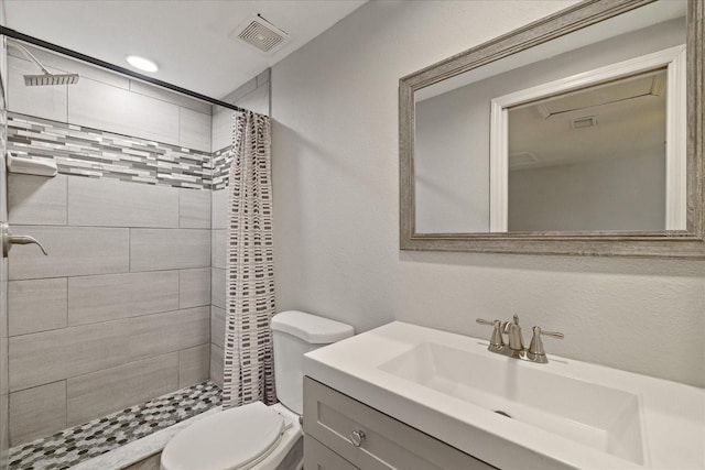 bathroom featuring vanity, a shower with shower curtain, and toilet