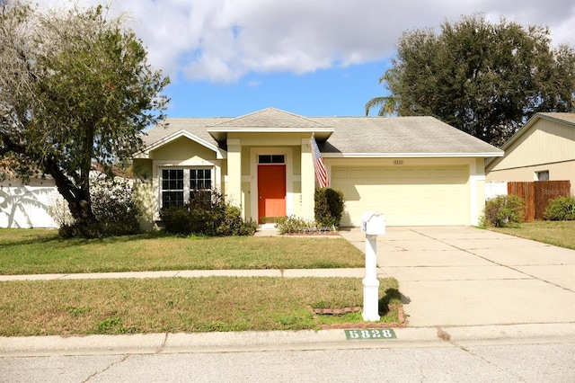 view of front of house featuring a garage and a front yard