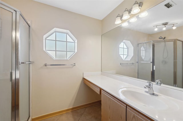 bathroom with tile patterned floors, an enclosed shower, and vanity