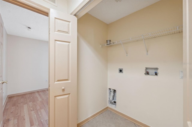 laundry room featuring electric dryer hookup, hookup for a washing machine, and light hardwood / wood-style floors