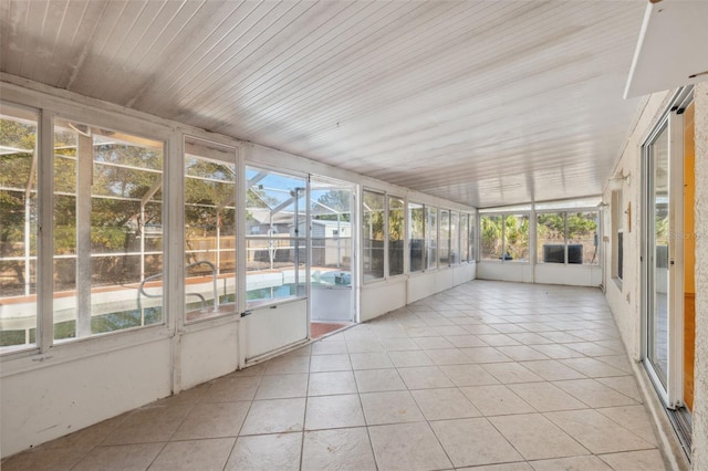 unfurnished sunroom featuring wooden ceiling