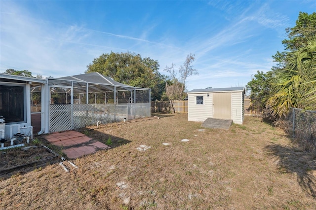 view of yard with a shed and glass enclosure