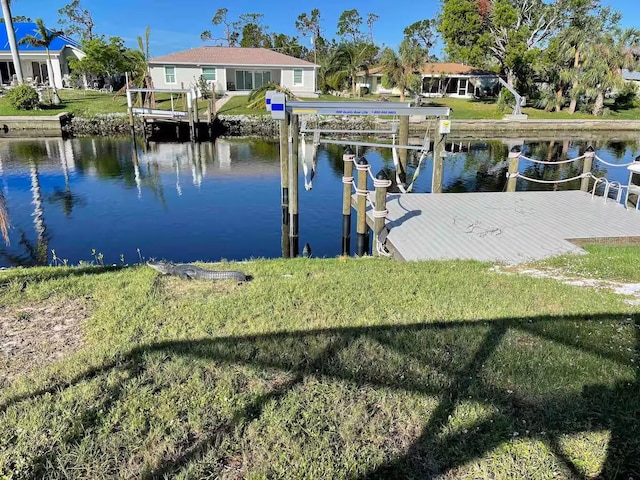 view of dock featuring a water view and a lawn