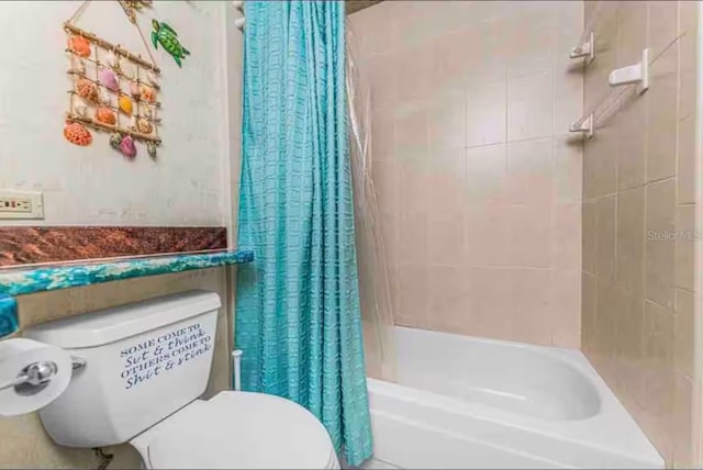 bathroom featuring shower / bath combo and toilet