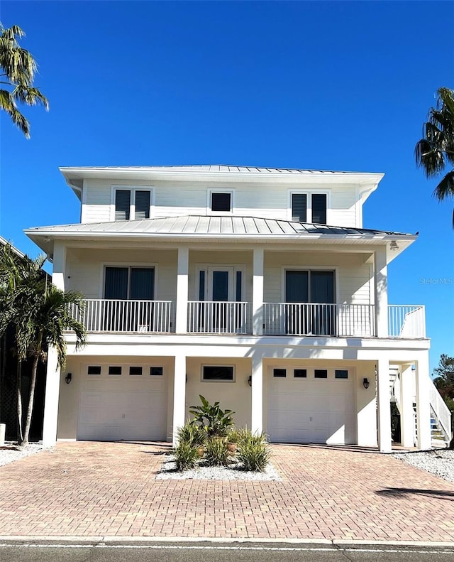 view of front facade featuring a garage and a balcony